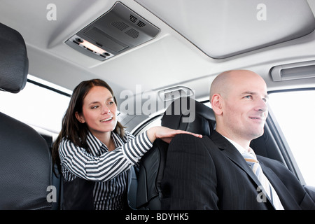 woman in car talking to driver Stock Photo