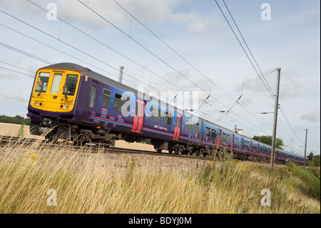 Class 319 train in First Capital Connect livery en route to Wimbledon travelling through the English countryside. Stock Photo