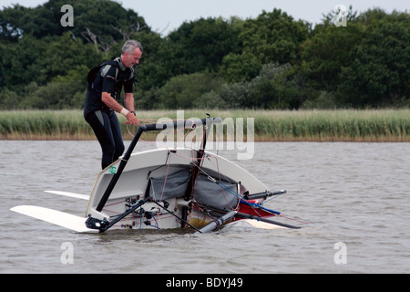 Yachtsman attempting to right his dinghy on Hickling Broad Stock Photo