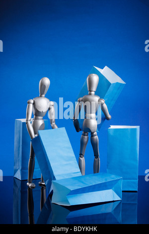 Silver dummies carrying gift bags Stock Photo