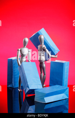 Silver dummies carrying gift bags Stock Photo