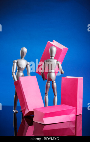 Silver dummies carrying gift bags Stock Photo