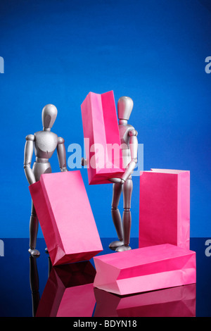 Silver dummies carrying gift bags Stock Photo