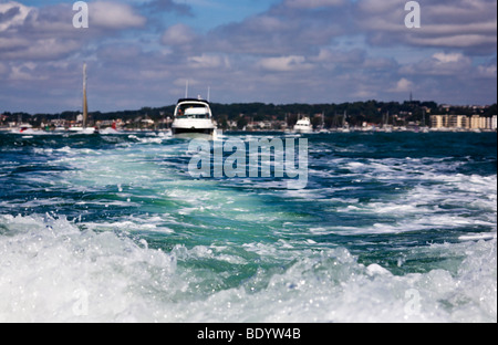 View from the back of a fast boat creating a wake in choppy sea. Leaving Poole harbour, Dorset. UK Stock Photo