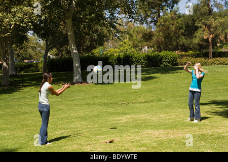 multi ethnic multi racial diversity racially diverse multicultural multi cultural Junior high girls play playing toss ball to each other. MR  © Myrlee Stock Photo