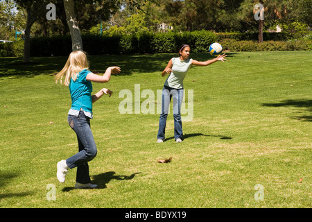 Two teen girls hang hanging out together Junior high girls toss ball to each other. 11-13 year old olds MR  © Myrleen Pearson Stock Photo