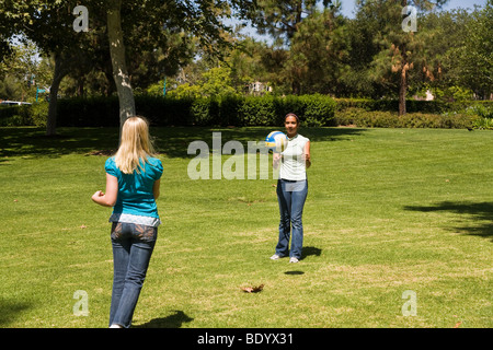 Two teen  girls hang hanging out together Junior high girls toss ball to each other. 11-13 year old olds  MR  © Myrleen Pearson Stock Photo