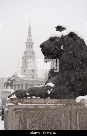 Snow on a lion statue, Trafalgar Square, London Stock Photo