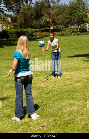 Two teen  girls hang hanging out together Junior high girls toss ball to each other. 11-13 year old olds MR  © Myrleen Pearson Stock Photo