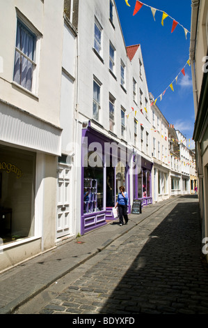 dh Mansell Street ST PETER PORT GUERNSEY Shopper looking in shop window Mansell Street St Peter Port strolling cobbled Stock Photo