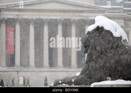Lion in Trafalgar square covered with snow. Stock Photo