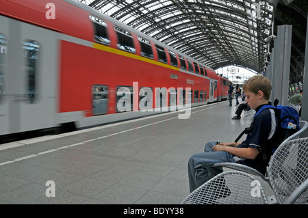 Boy, 9, waiting for a train, main railway station in Cologne, North Rhine-Westphalia, Germany, Europe Stock Photo