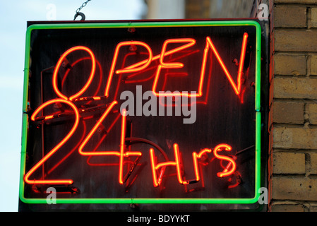 Open 24 hours shop neon sign lit up Stock Photo