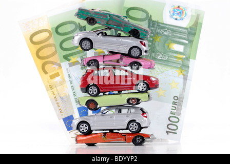 Stack of damaged and new miniature cars, a symbolic image for the faltering sale of new vehicles after the end of the scrapping