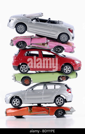 Stack of damaged and new miniature cars, a symbolic image for the faltering sale of new vehicles after the end of the scrapping