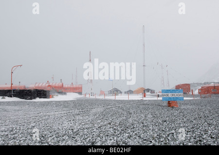 Base Orcadas Argentinian research station and military base Antarctica during windy summer blizzard script sign with global position Stock Photo