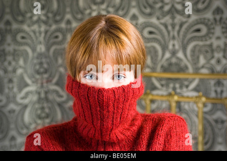 woman with jumper pulled over face Stock Photo