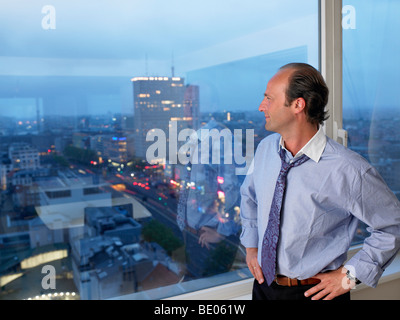 Business man looking through the window Stock Photo