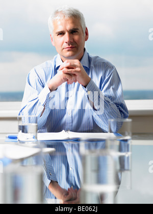Business man sitting at his desk Stock Photo