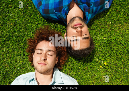 Two young men relaxing on grass Stock Photo