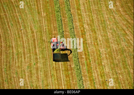 Aerial view of tractor harvesting hay Stock Photo