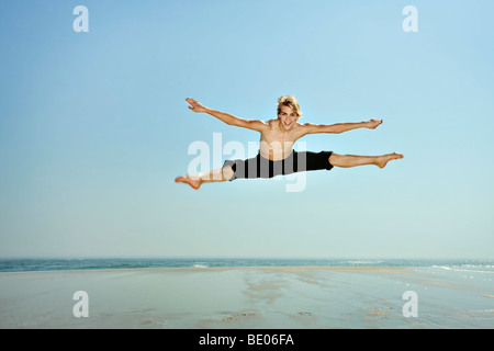 Young man doing splits in the air Stock Photo