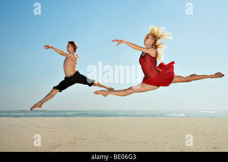 Dancers leaping on a beach Stock Photo
