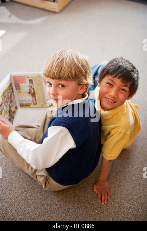 Students reading book together Stock Photo