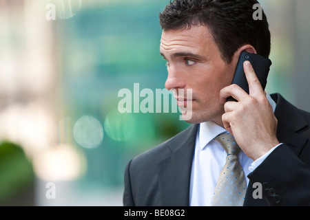 A young male executive on his mobile phone in a modern city Stock Photo