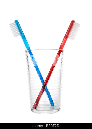 Two toothbrushes in a glass over white background Stock Photo - Alamy