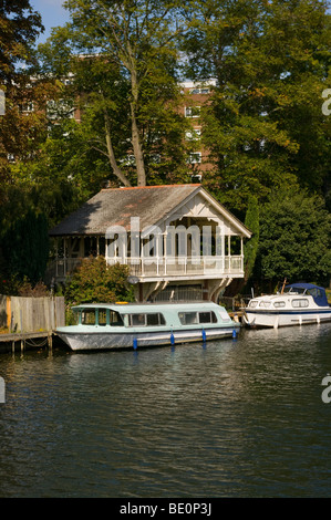 A Riverside Boathouse And Moored Boats On The River Thames at Teddington Middlesex England Stock Photo