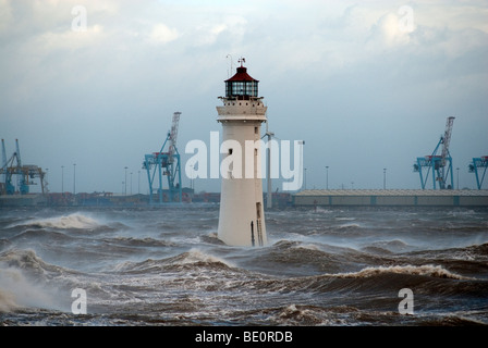 High winds and stormy seas at New Brighton, River Mersey UK with Lighthouse and castle Stock Photo