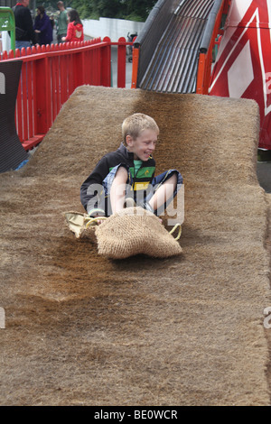 Boy on Helter Skelter at Funfair Stock Photo