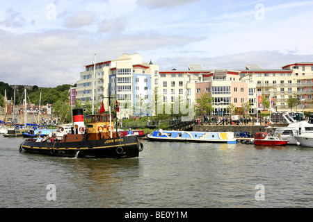 Old Tugboat 'John King' in Bristol Harbour with modern development apartments in the background on old warehouse land Stock Photo
