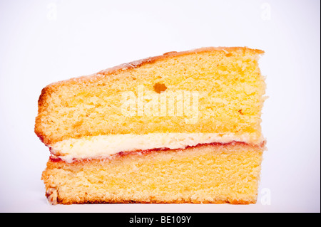 A close up of a slice of victoria sponge cake on a white background Stock Photo