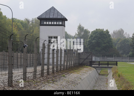 Watchtowers, barbed wire fence in former Dachau concentration camp, Germany Stock Photo