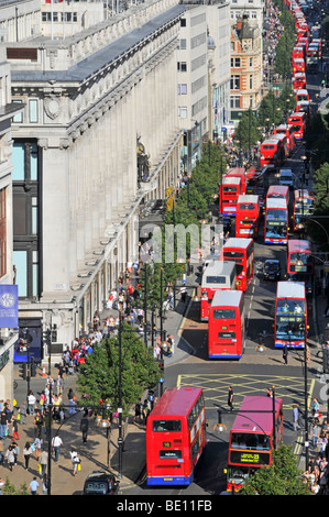 Looking down on UK Oxford Street with shoppers & aerial views of long queues of tfl double decker red London buses outside Selfridges department store Stock Photo