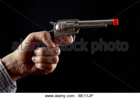 Man holding toy gun Stock Photo