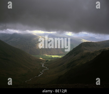 Sunlight breaking through low cloud over Mosedale and Wasdale Head from Wind Gap between Pillar and Scoat Fell Cumbria England Stock Photo