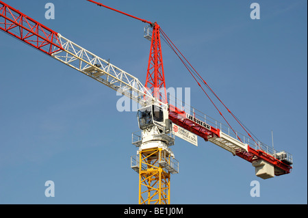 colorful tower crane against clear blue sky Stock Photo