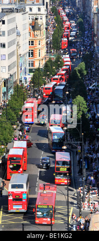 London Oxford Street West End aerial views of long queues of double decker red London shoppers buses at bus stops & traffic lights England UK Stock Photo
