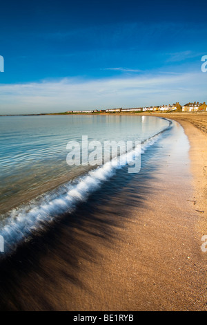 England, Northumberland, Newbiggin by the sea. Coal dust revealed by a retreating wave on the Newbiggin by the sea beach. Stock Photo