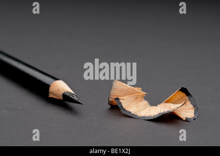 Horizontal close up of a sharpened black pencil with shavings Stock Photo