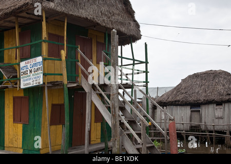 The Carrefour Inn in Ganvie, Benin provides lodging for tourists in straw-roofed houses. Stock Photo