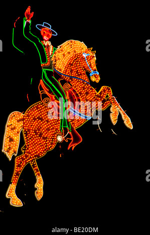Cowboy on horse sign at night, Las Vegas Stock Photo