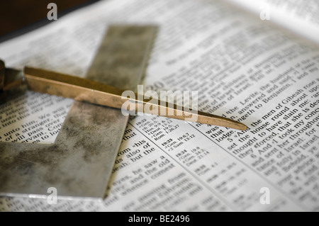 Masonic symbol of a set square and pair of compasses on an open Bible Stock Photo