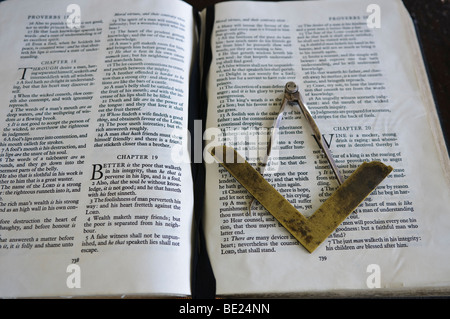 Masonic symbol of a set square and pair of compasses on an open Bible Stock Photo