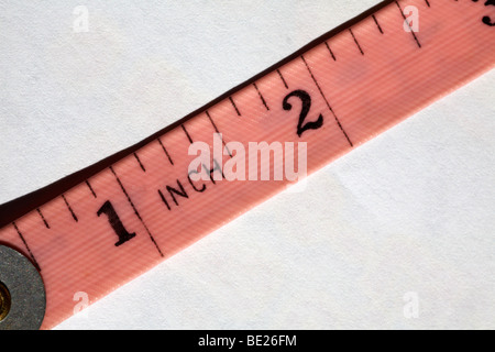 Beginning of measuring tape close up - tape measure set on white background Stock Photo