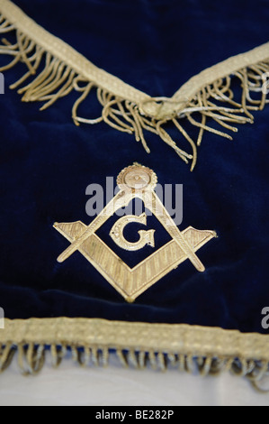 Masonic symbol of Set Square, pair of compasses, and the letter 'G' on a ceremonial apron Stock Photo