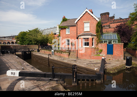 Manchester, England, UK. Dukes Lock gates 92 and Lock Keepers Cottage on the Rochdale canal in Castlefield Urban Heritage Park Stock Photo